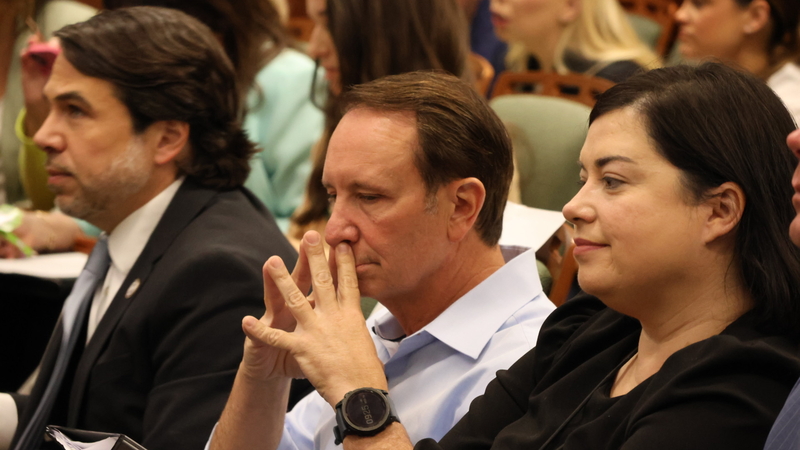 Gov. Jeff Landry sitting among crowd in House committee room