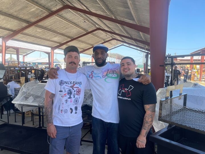 three men pose together