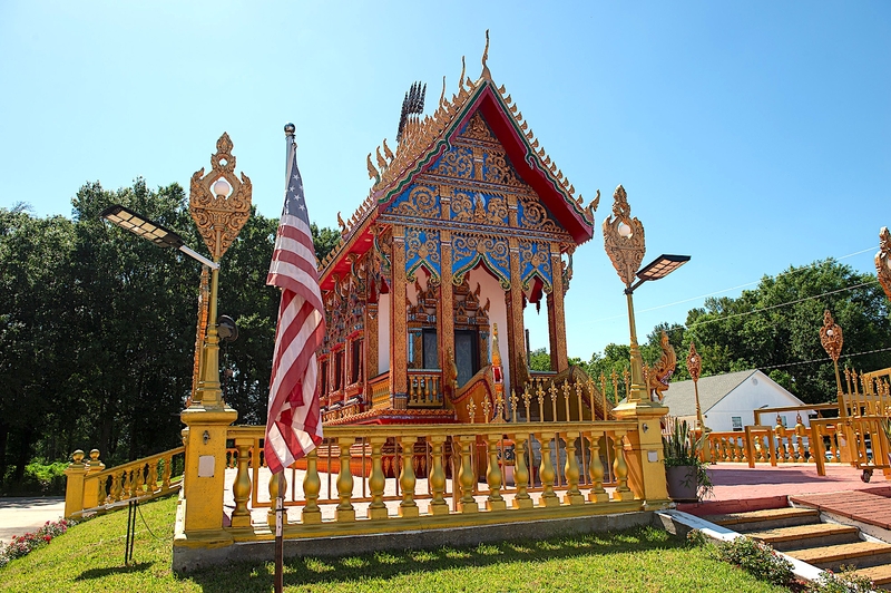 An American flag and Laotian ornamentation highlights a building specifically for monks at the Wat Thammarattanaram temple complex in Broussard