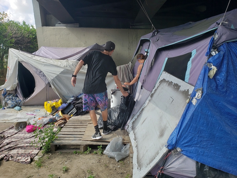 In this 2022 photo, Terry Acevado, left, and Jessica Baudean prepare to move out of a tent under the Pontchartrain Expressway in New Orleans