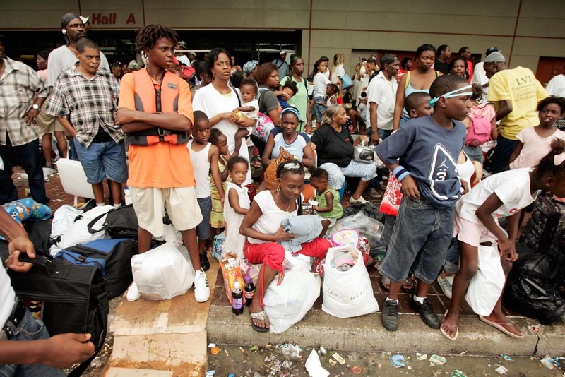 People who escaped flooding after Hurricane Katrina caused levees to fail in New Orleans await aid and treatment outside the Morial Convention Center