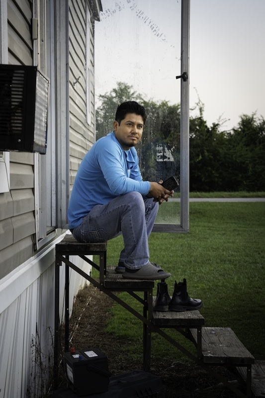 Leonardo Garcia Venegas, 25, sits for a photo outside of his home