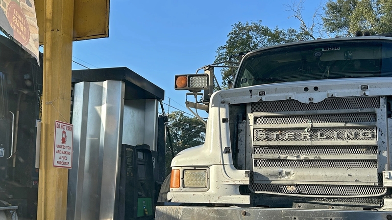 A pair of dump trucks at a gas pump in Delhi, Louisiana