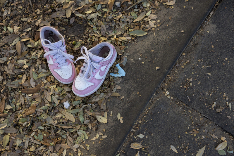 A child’s shoes are left in the dirt next to the playground at Mickey Markey Park in the Bywater neighborhood of New Orleans