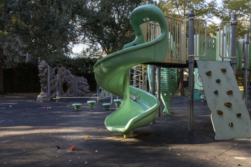 A child goes down a spiral slide at the Daneel Playground in Uptown New Orleans
