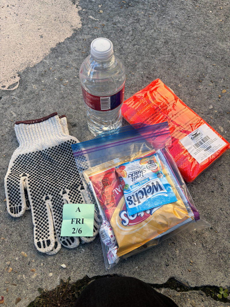 The package provided to Mardi Gras parade clean-up workers includes work gloves, a 12-ounce bottle of water, wet wipes and a plastic bag with snacks that include chips, fruit gummies, a granola bar and a Blow Pop