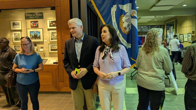 U.S. Sen. Bill Cassidy, with his wife, Dr. Laura Cassidy, speaks with reporters