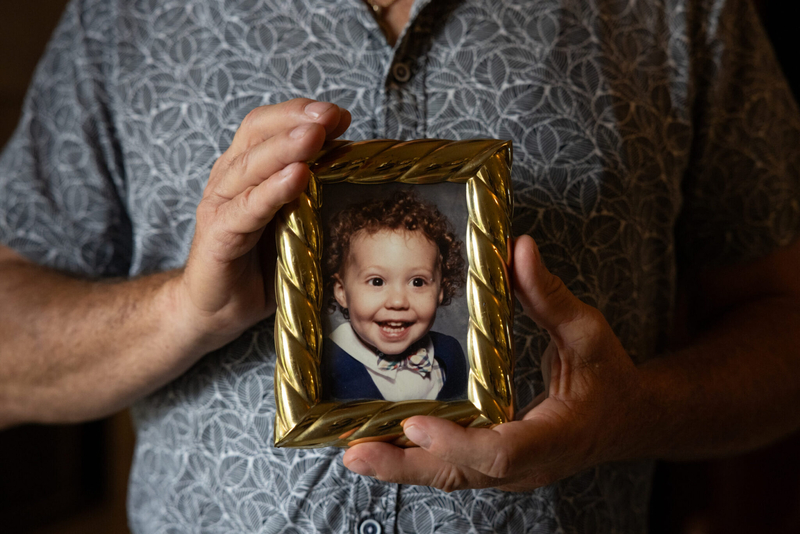 Danny Bolner Jr. holds a framed photo of his son Daniel