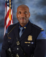 Complaint alleges Michigan police director and top deputy improperly received bonuses
