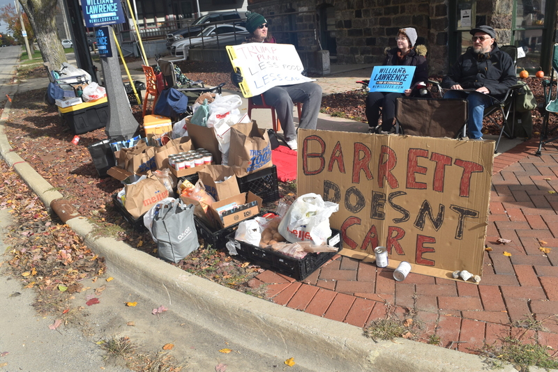 Congressional candidate hosts food drive and vigil outside Rep. Tom Barrett’s Lansing office