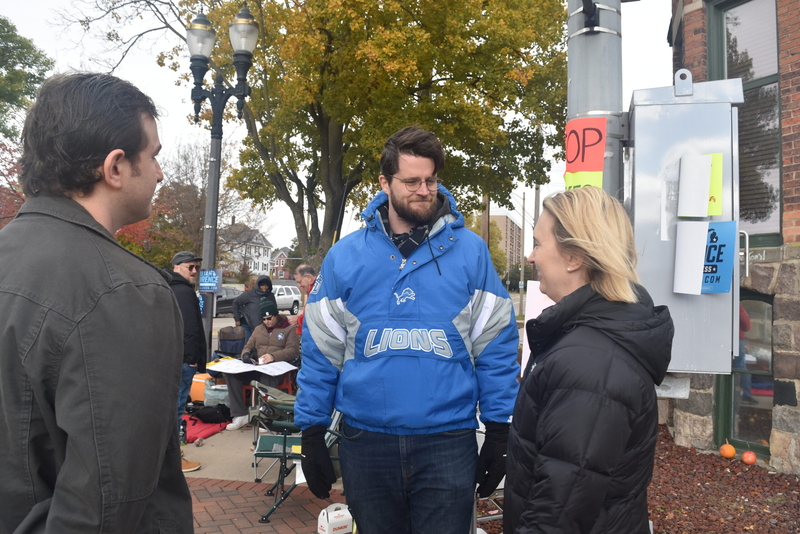 Congressional candidate hosts food drive and vigil outside Rep. Tom Barrett’s Lansing office