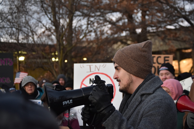 State Sen. Darrin Camilleri (D-Trenton) holding a megaphone