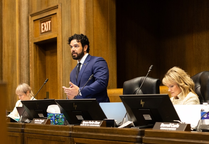Johnathan Duncan stands and speaks to the rest of the council.