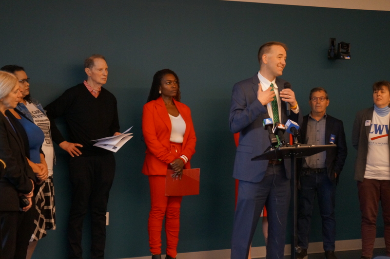 Oregon State Treasurer Tobias Read (right) at a news conference with Nkenge Harmon Johnson (center), president and CEO of Urban League of Portland and U.S. Sen. Ron Wyden (left) at a news conference at the Albina Library in Portland on Friday, March 13, 2026 warning voters about election supression. (Photo by Alex Baumhardt/Oregon Capital Chronicle)