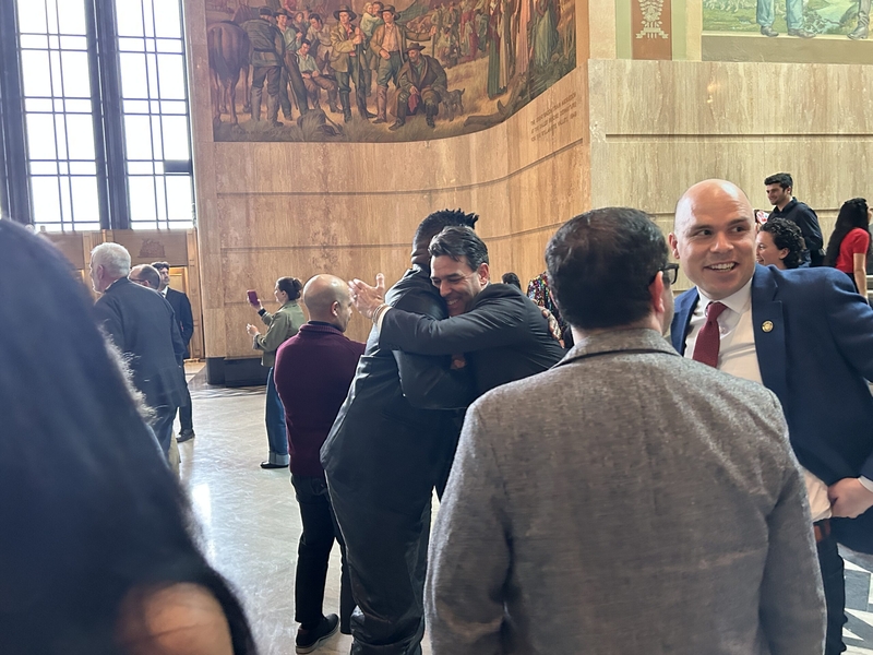 Rep. Travis Nelson, D-Portland, (left) hugs Senate President Rob Wagner, D-Lake Oswego, (right) in the Rotunda of the State Capitol in Salem on Friday, March 6, 2026 following the end of the 2026 legislative session. (Photo by Alex Baumhardt/Oregon Capital Chronicle)