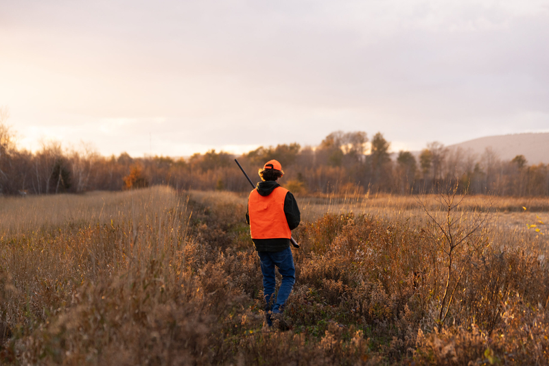 A hunter walks across a field. (Getty Images)