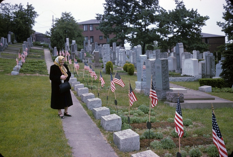 In March 1949, Irwin Fox was buried at Shaare Torah Cemetery in Whitehall in Allegheny County. A family photo dated Sept. 15, 1964, shows his mother standing in front of his grave marked by an American flag. (Courtesy of Irwin Fox)