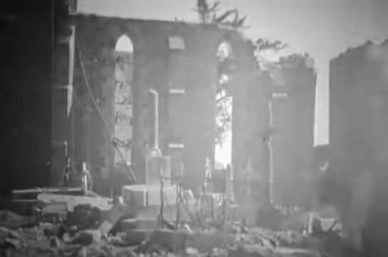 A cemetery in Gathemo, France, stands amid the ruins of the town in August, 1944. (Courtesy of the National Archives)