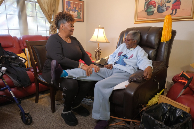 Engram massages Stokes’ leg to increase blood circulation before their daily walk. (Photo by Jeff Ricker for Capital &amp; Main)
