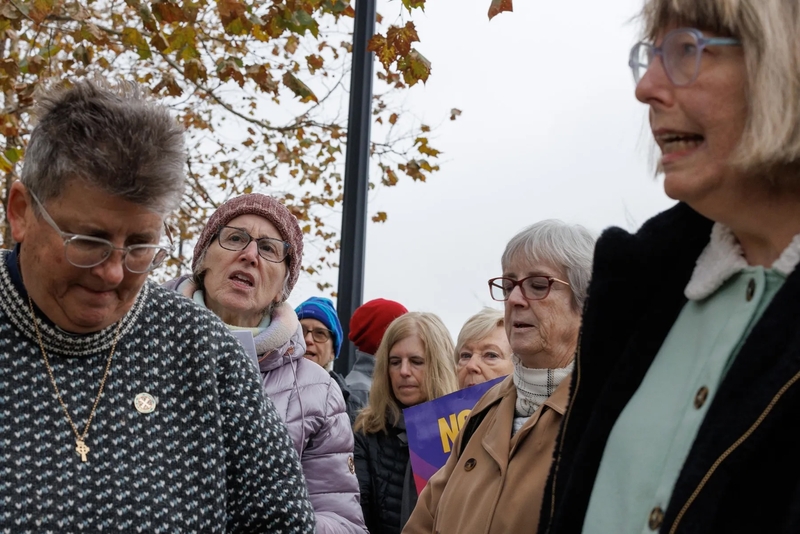 People sing during a vigil held in front of ICE’s Pittsburgh field office on Nov. 21. (Photo by Quinn Glabicki/Pittsburgh’s Public Source)