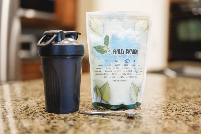 A bag of kratom and a shake cup a pictured at Lora Romney’s home in Layton on Thursday, Feb. 5, 2026. Romney, 55, has atypical trigeminal neuralgia, which causes intense, burning, nerve pain in her face. Kratom, which the Utah legislature is considering banning, is the only non-opiate that she has found to alleviate the pain. (Photo by Spenser Heaps for Utah News Dispatch)