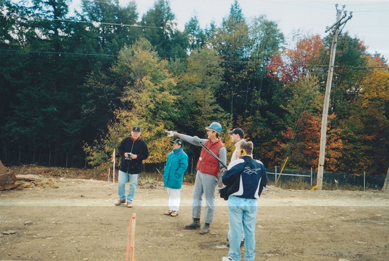 Somerset County Coroner Wallace Miller (center) describes the crash of Flight 93 to Tim Lambert (first on the right), then-WITF News Director Damon Boughamer (holding microphone. Lambert's father is on the far left and Irene Vigosky is next to Miller. The coroner explained why Lambert's land was considered an essential part of the crash site. (Photo courtesy of Tim Lambert)
