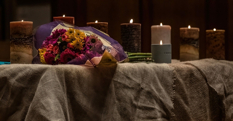 Seven candles burn on the altar at Belmont United Methodist Church, one for each of the shooting victims and one for the shooter. (Photo: John Partipilo)