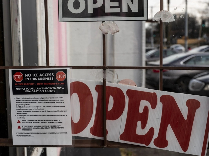 A sign on the door of a business